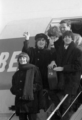 The Beatles and manager Brian Epstein coming off of the BEA airplane moments after landing in Austria on March 13, 1965.