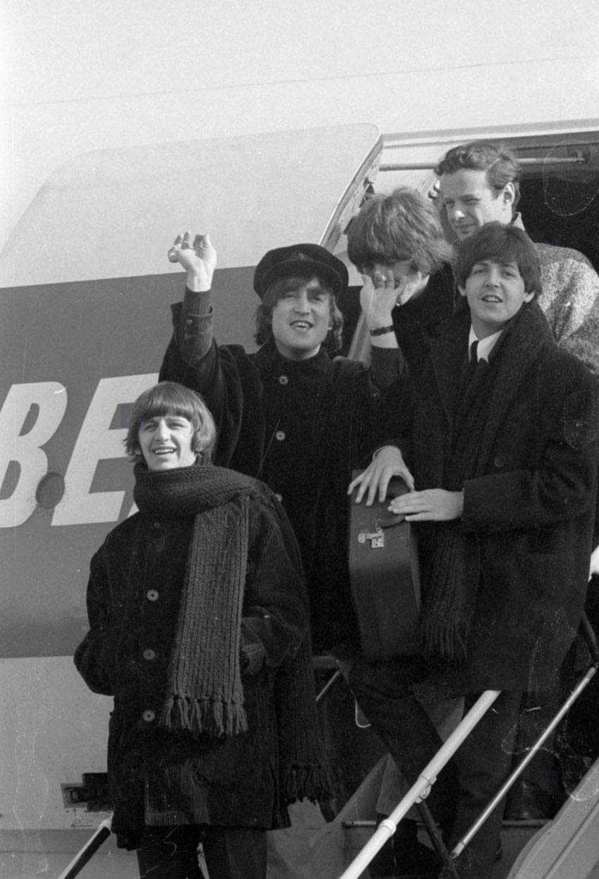 Beatles SI42D The Beatles and manager Brian Epstein coming off of the BEA airplane moments after landing in Austria on March 13, 1965.