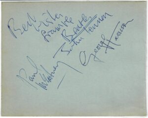 A blue autograph album page signed by John Lennon, Paul McCartney and George Harrison, with John writing "Best wishes from the Beatles".