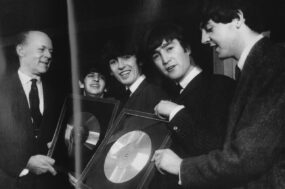 The Beatles on November 18, 1963 - the day they signed this album along with Brian Epstein.
